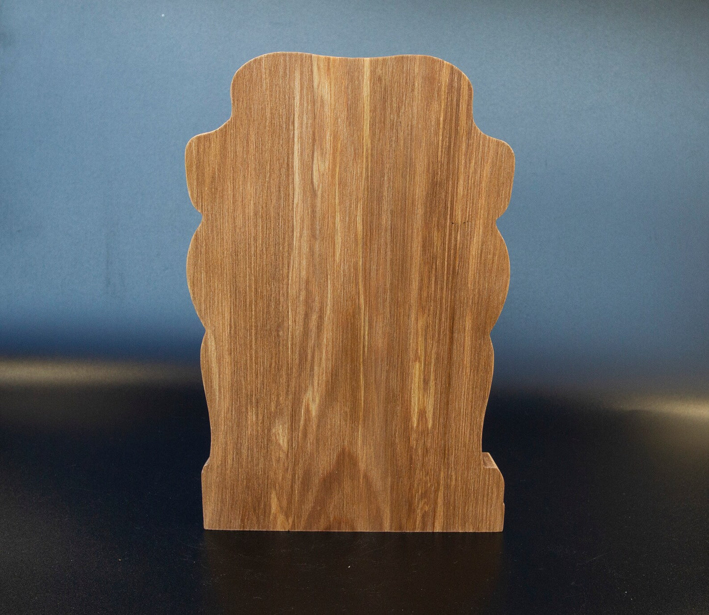 Back view of wooden Ullr figurine showing smooth carved wood grain on solid Viking statue silhouette