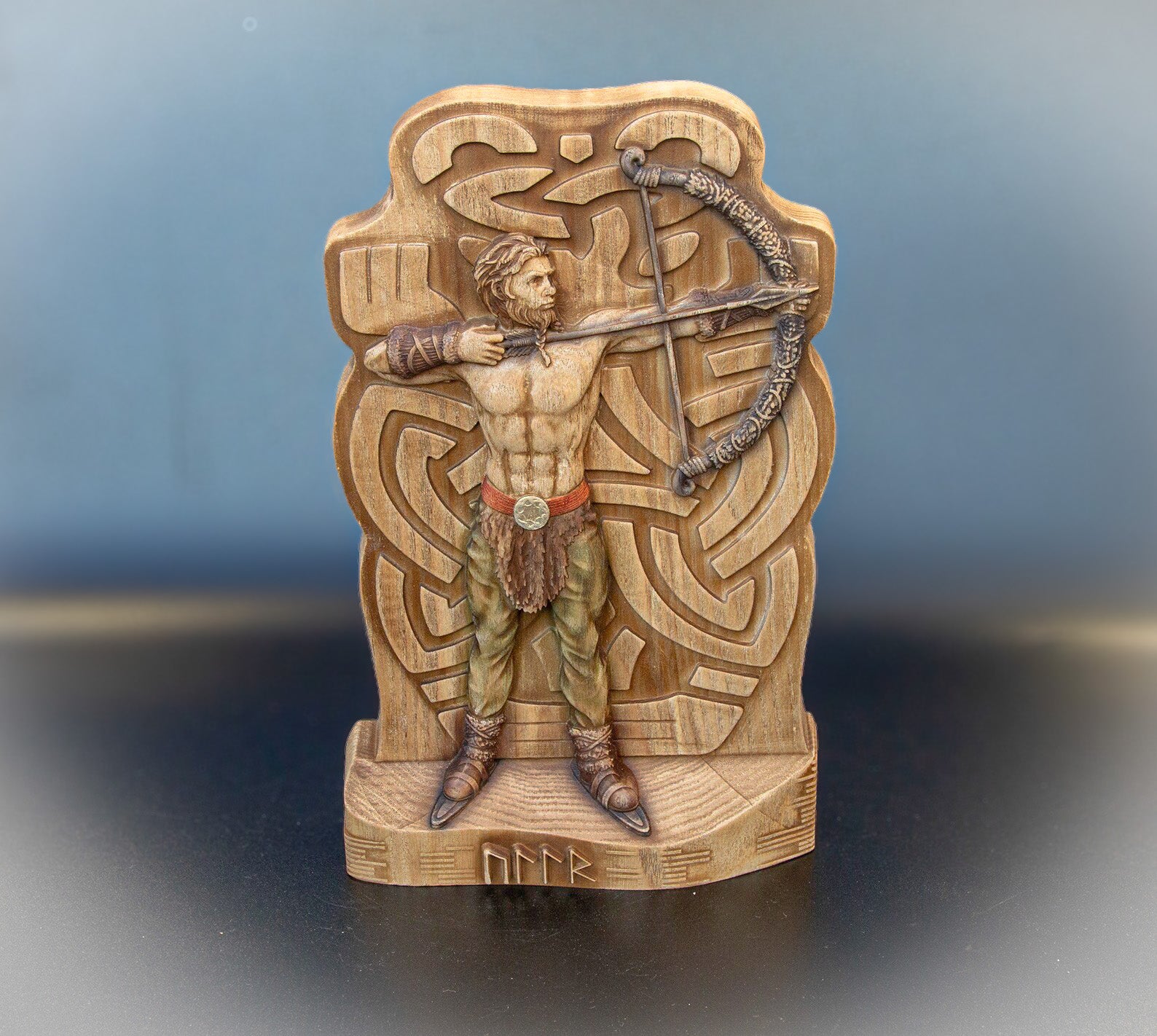 Wooden Ullr figurine of Norse god archer aiming bow, carved Viking decor statue for winter, hunting and archery altar display.